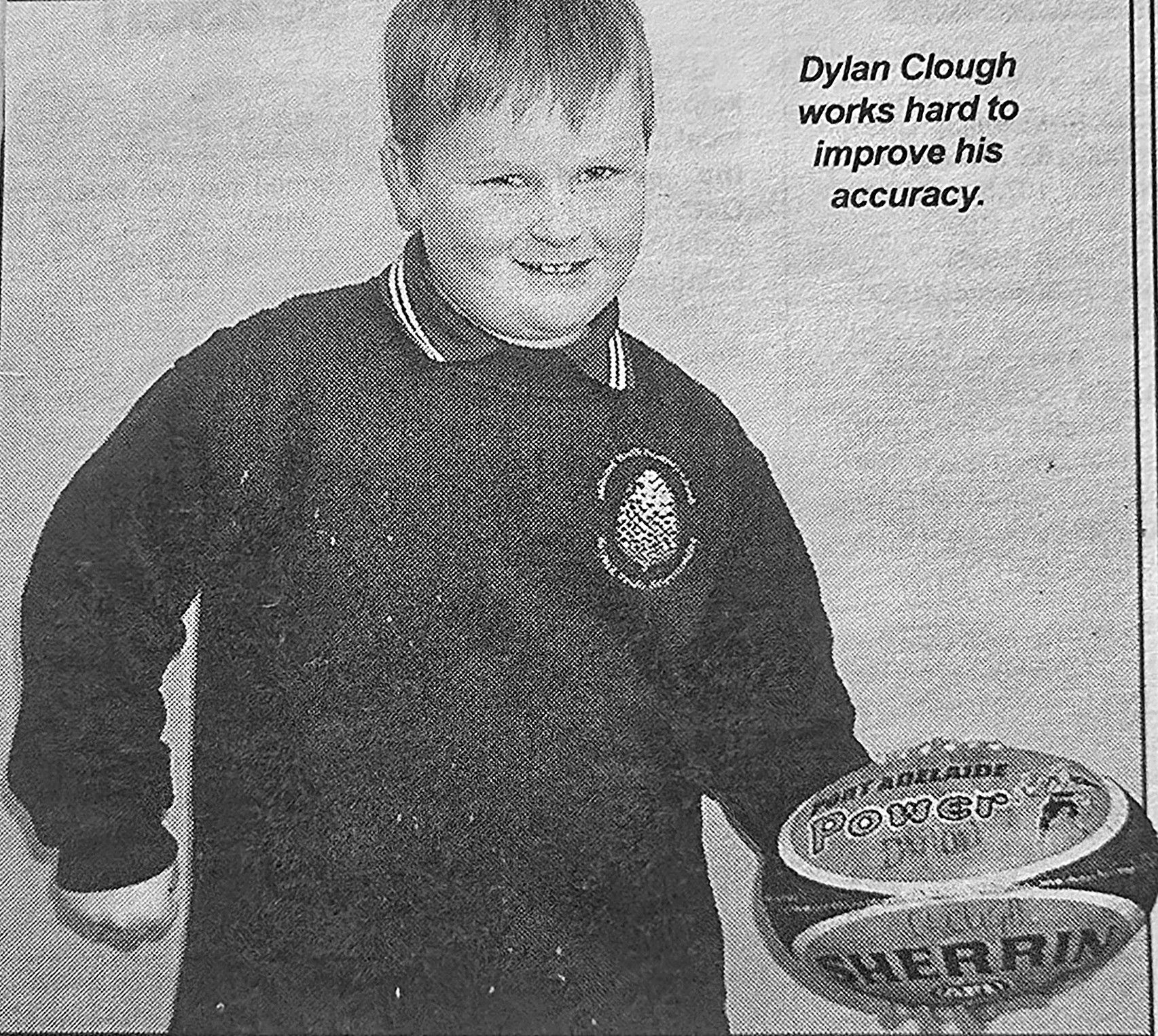 Dylan Clough, aged eight, holding a Port Adelaide Sherrin football, September 2002