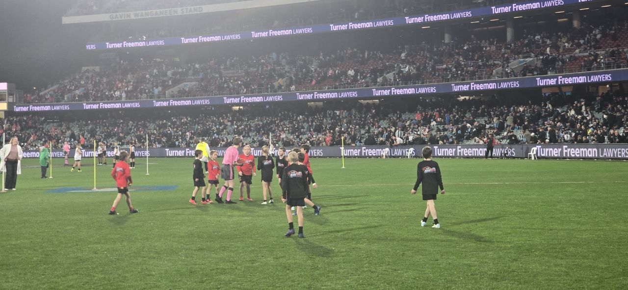 Auskick on the ground at Adelaide Oval, 2026, with the crowd in the stands