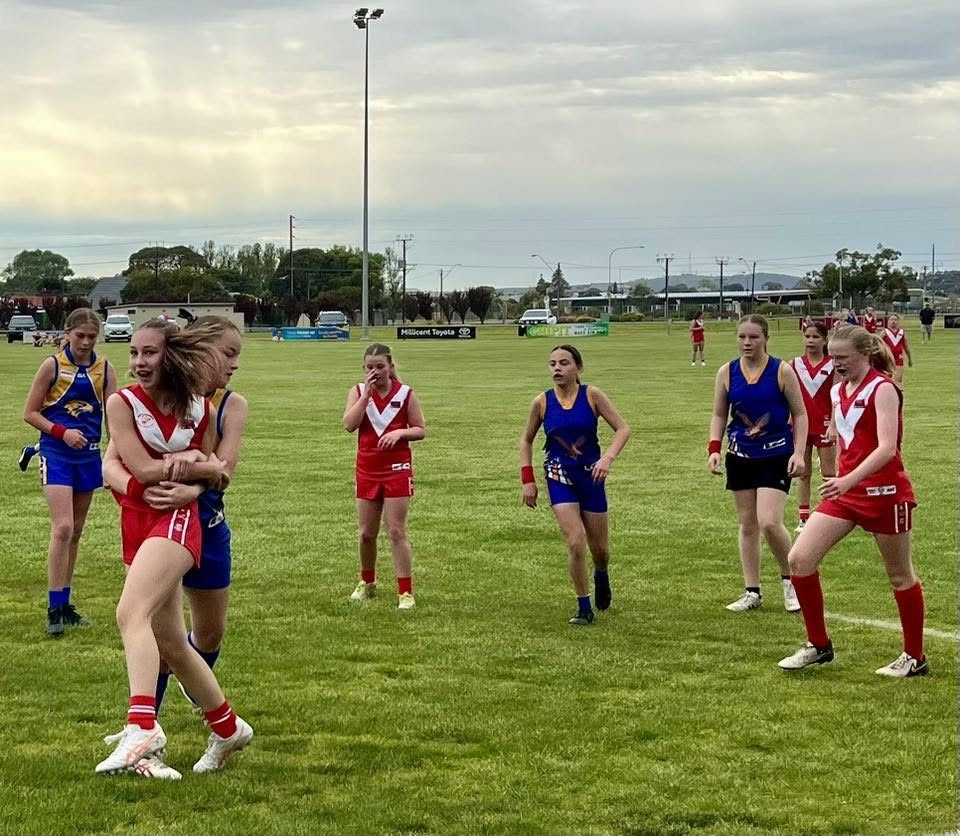 Hatherleigh girls contest with the opposition in red