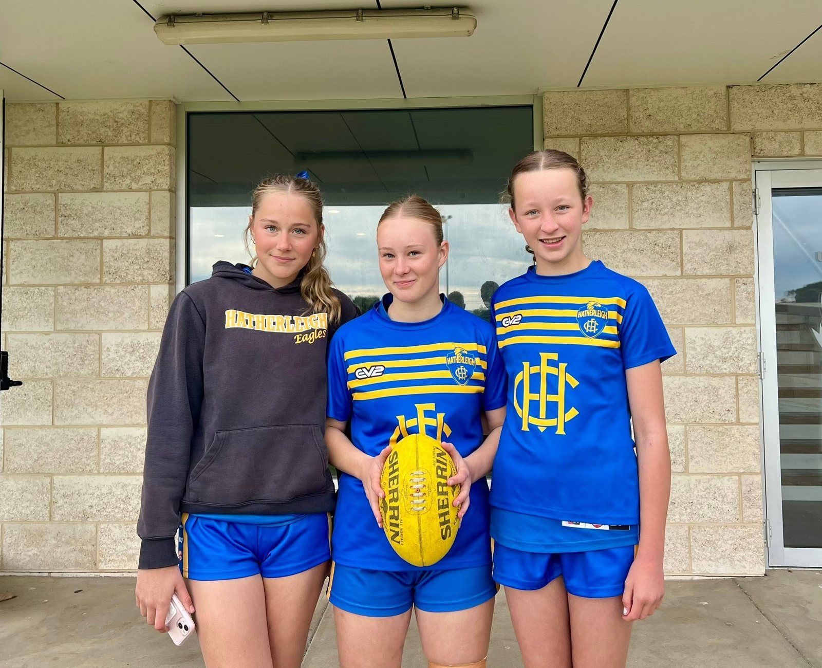 Three Hatherleigh girls in club colours with a Sherrin