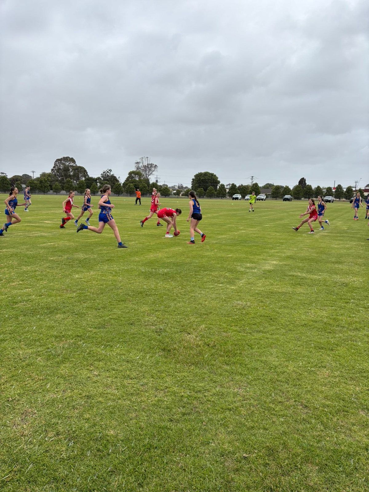 Hatherleigh girls in blue and gold chase the ball in an LCWFL game