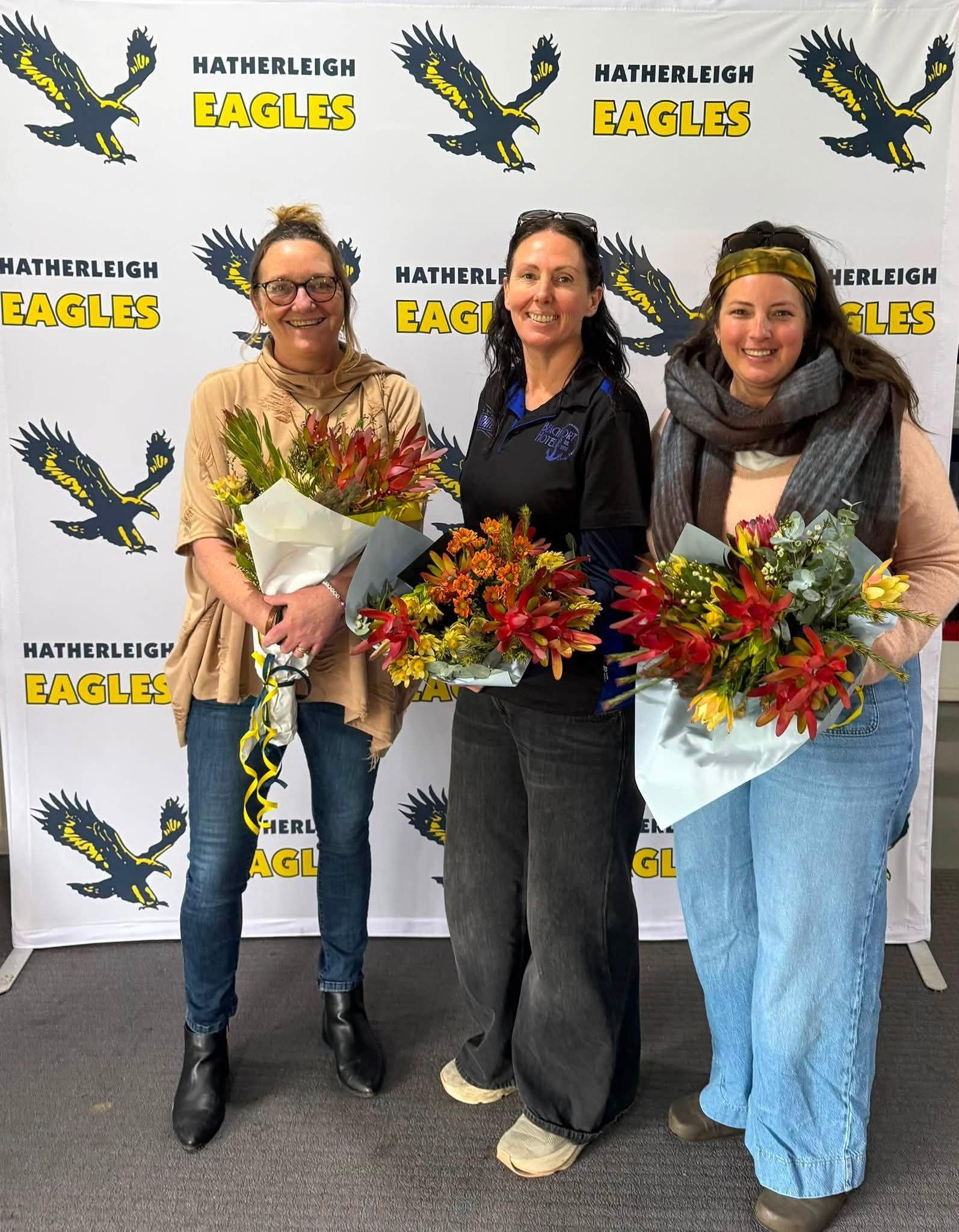 Hatherleigh trainers Sam, Kylie and Stacey with flowers in thanks for their work in 2026