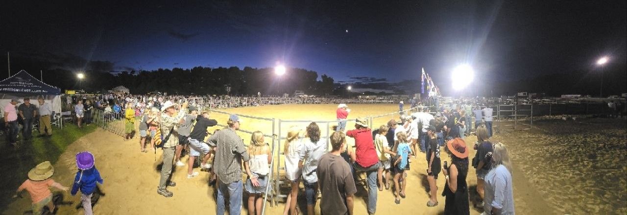 Panorama of the Hatherleigh Rodeo arena at dusk with a big crowd