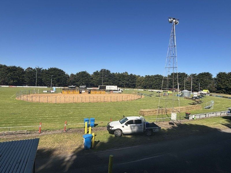 The rodeo arena, hay bales and lighting tower set up, seen from the clubrooms