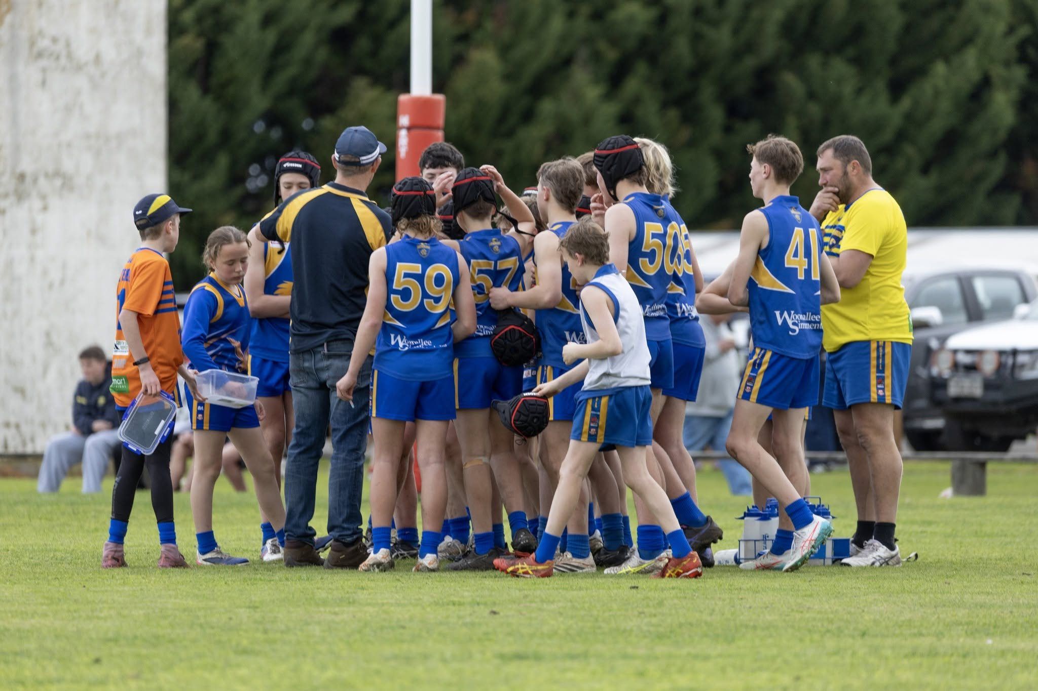 Hatherleigh Junior Colts huddle with their coaches during a break