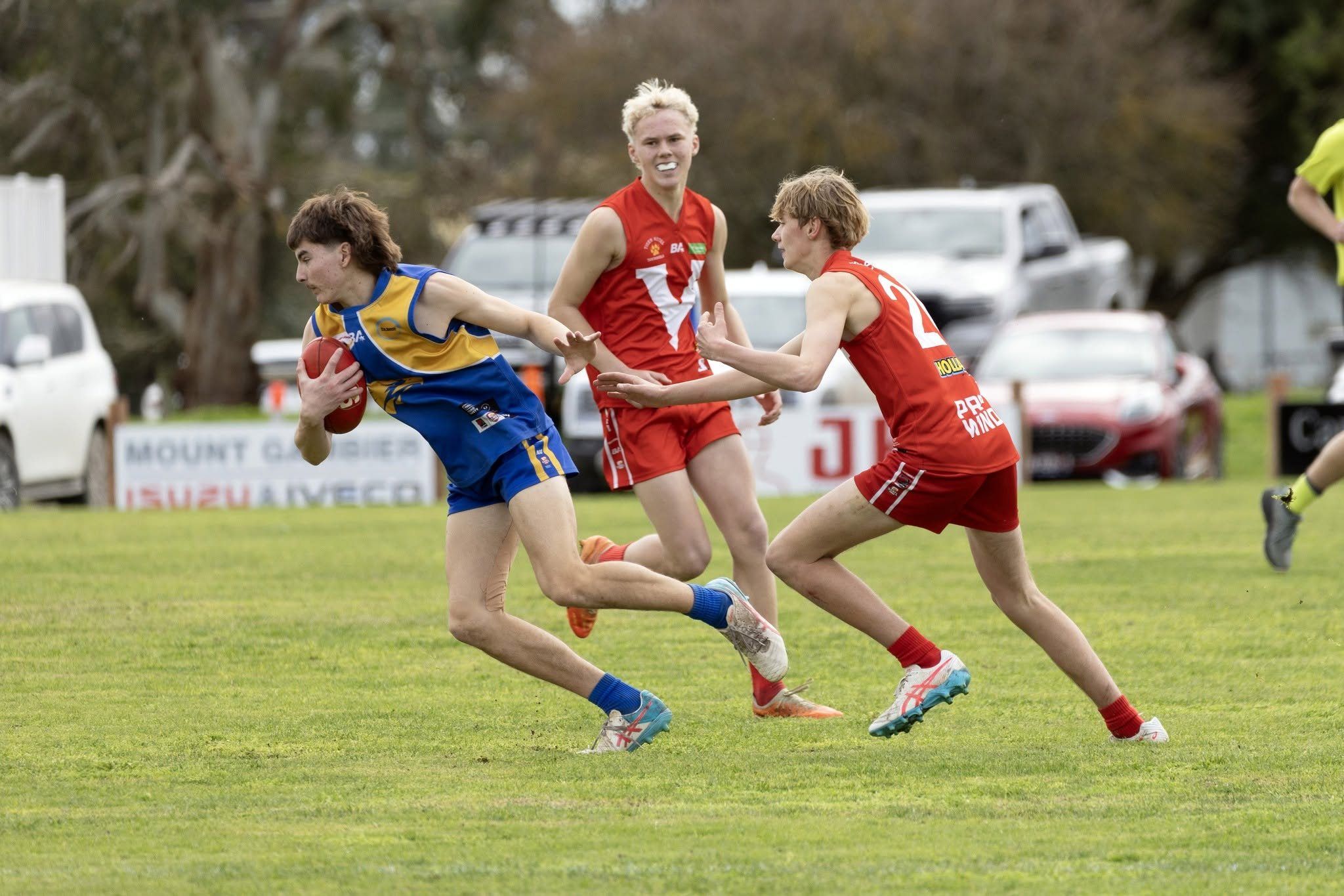 A Hatherleigh Senior Colts player fends off a Tantanoola opponent