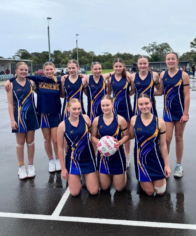 Hatherleigh U15 netball team photo on the courts after a wet game