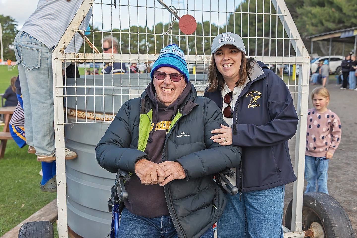 Kate Nowak and Reg Hamilton in Big Freeze beanies beside the dunk tank at the FightMND fundraiser