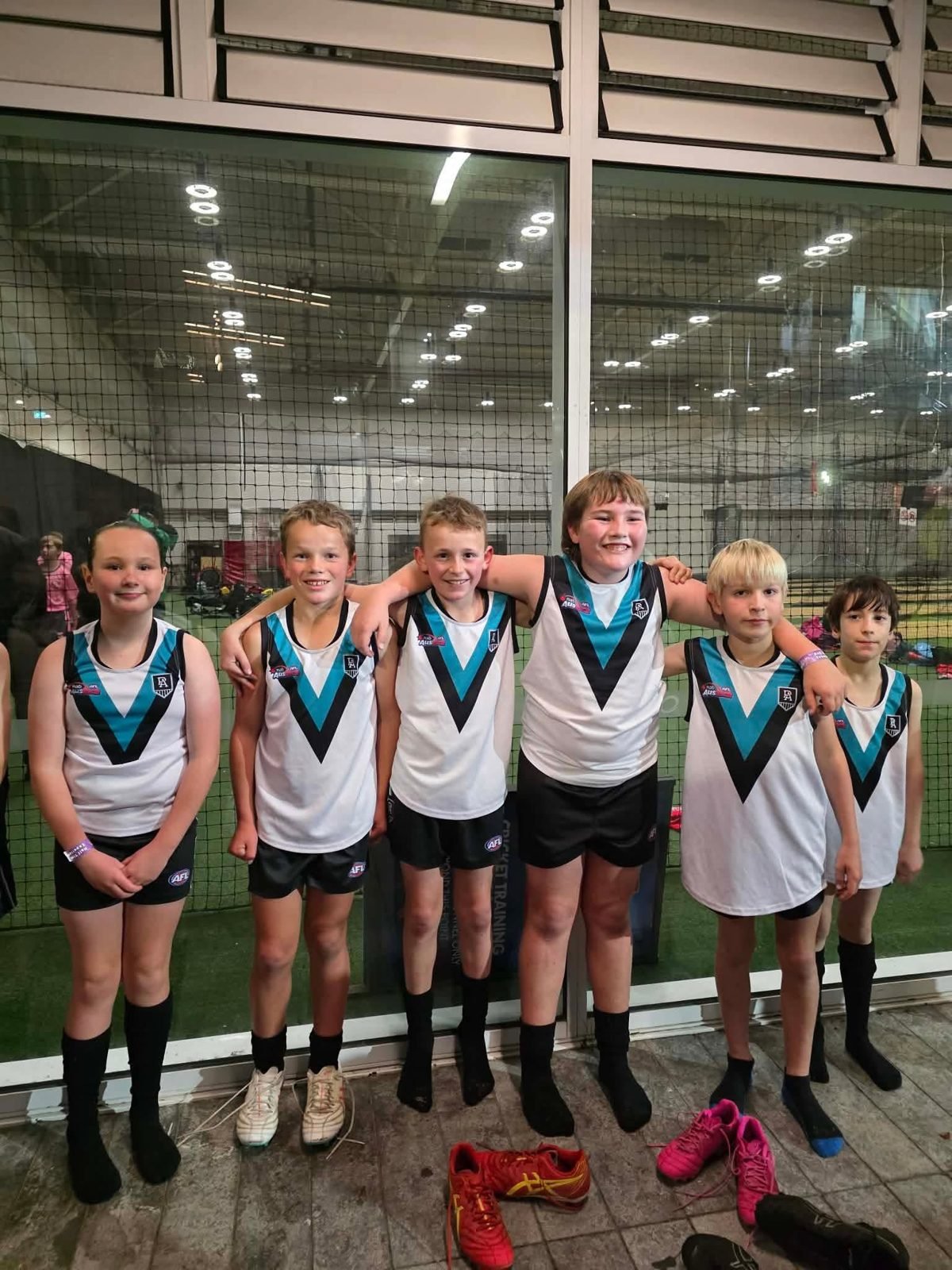 Hatherleigh juniors in Port Adelaide Little League guernseys before running out at Adelaide Oval