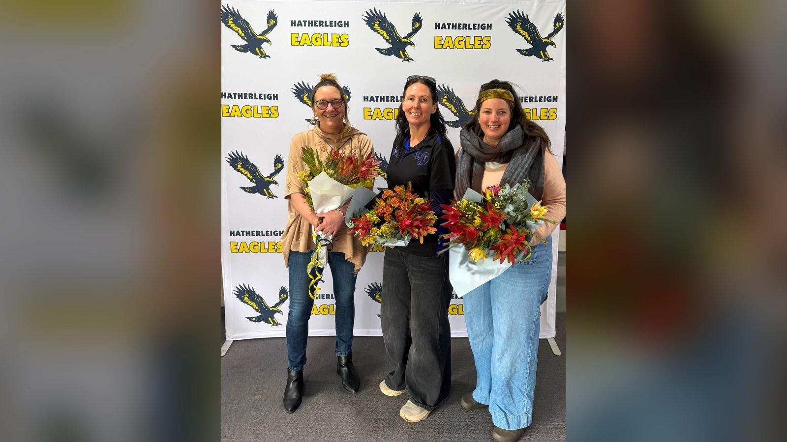 Hatherleigh trainers Sam, Kylie and Stacey with flowers in thanks for their work in 2026